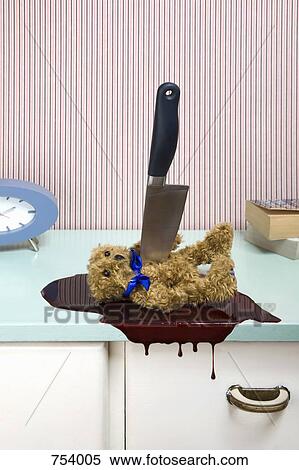 Knife stabbing a teddy bear on a dresser View Large Photo Image Stock Photography - Knife stabbing a teddy bear on a dresser. Fotosearch