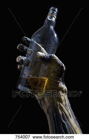 Monster's hand holding a bottle View Large Photo Image Stock Photo - Monster's hand holding a bottle. Fotosearch
