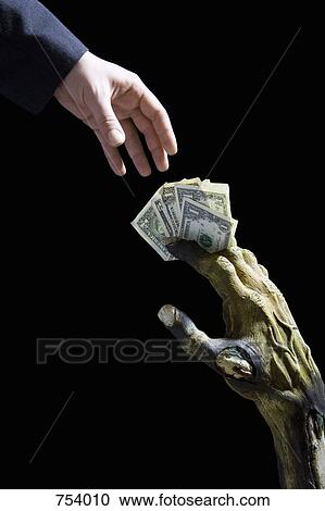 Monster's hand passing money to a businessman View Large Photo Image Stock Image - Monster's hand passing money to a businessman. Fotosearch