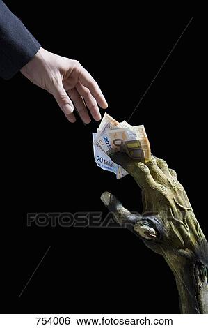 Monster's hand passing money to a businessman View Large Photo Image Stock Photograph - Monster's hand passing money to a businessman. Fotosearch