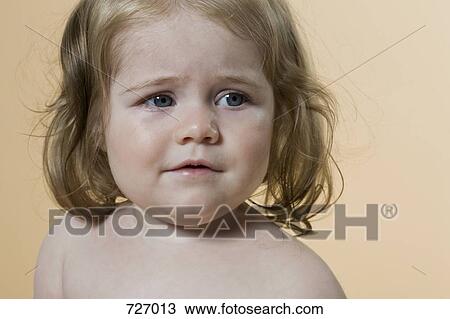 Portrait of a young girl frowning View Large Photo Image Stock Image - Portrait of a young girl frowning. Fotosearch