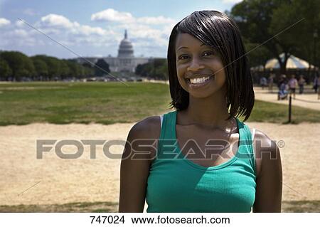 Portrait of a young woman in front of the Capitol Building, Washington DC, USA View Large Photo Image Picture - Portrait of a young woman in front of the Capitol Building, Washington DC, USA. Fotosearch