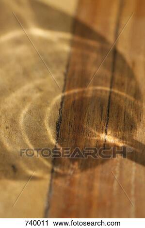 Stock Image - Shadow of a wine glass on wood. Fotosearch