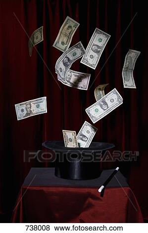 US currency bills coming out of a top hat at a magic show View Large Photo Image Stock Photo - US currency bills coming out of a top hat at a magic show. Fotosearch