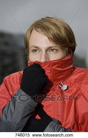 Young man with collar of rain jacket covering mouth View Large Photo Image Stock Photography - Young man with collar of rain jacket covering mouth. Fotosearch