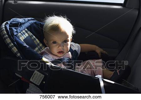A baby sitting in a car seat View Large Photo Image Stock Photo - A baby sitting in a car seat. Fotosearch