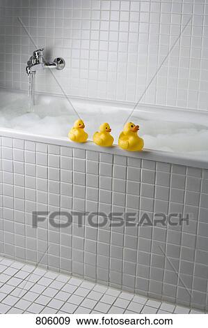 A bubble bath with rubber ducks on side of tub View Large Photo Image Stock Photo - A bubble bath with rubber ducks on side of tub. Fotosearch