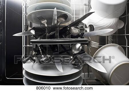 Stock Image - A dishwasher with knives sticking dangerously point side up. Fotosearch