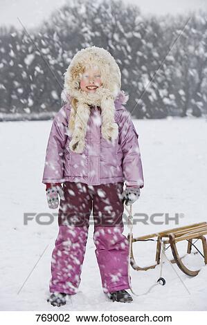 A girl with a sled, outdoors View Large Photo Image Stock Image - A girl with a sled, outdoors. Fotosearch