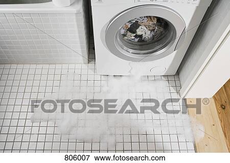 A leaking washing machine View Large Photo Image Stock Photo - A leaking washing machine. Fotosearch