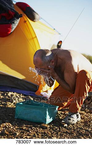 A man splashing water on his face View Large Photo Image Stock Photo - A man splashing water on his face. Fotosearch