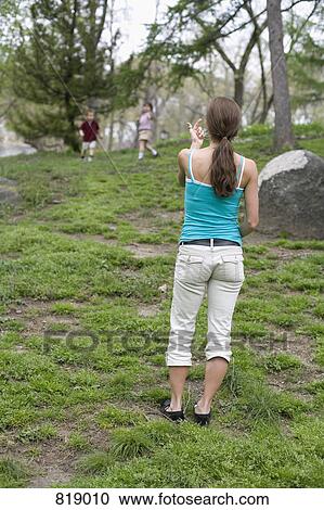 A mother beckoning her children in Central Park, New York City View Large Photo Image Stock Image - A mother beckoning her children in Central Park, New York City. Fotosearch