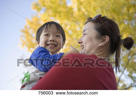 A mother holding her son, portrait View Large Photo Image Stock Image - A mother holding her son, portrait. Fotosearch