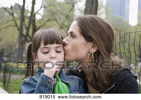A mother kissing her daughter in Central Park, New York City View Large Photo Image Stock Photography - A mother kissing her daughter in Central Park, New York City. Fotosearch