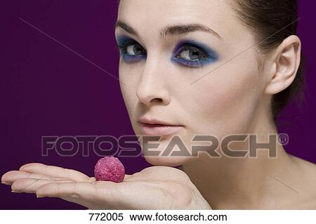 A woman holding a Kir Royal truffle View Large Photo Image Stock Photography - A woman holding a Kir Royal truffle. Fotosearch