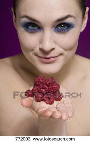 A woman holding out her hand piled with raspberry View Large Photo Image Stock Image - A woman holding out her hand piled with raspberry. Fotosearch