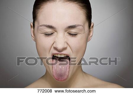 A woman sticking out her tongue View Large Photo Image Stock Photo - A woman sticking out her tongue. Fotosearch