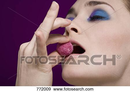 A woman tasting a Kir Royal truffle View Large Photo Image Stock Photo - A woman tasting a Kir Royal truffle. Fotosearch
