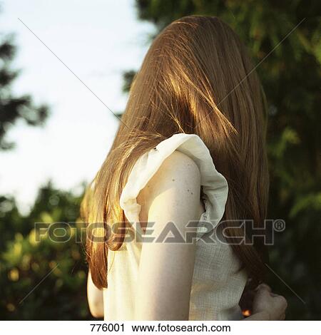 A woman with hair completely covering her face View Large Photo Image Stock Image - A woman with hair completely covering her face. Fotosearch