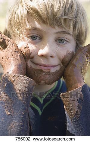 A young boy playing with mud View Large Photo Image Stock Image - A young boy playing with mud. Fotosearch