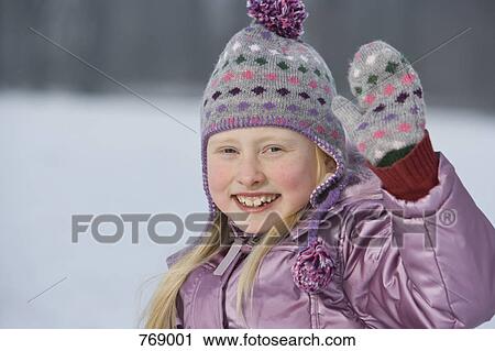 A young girl in winter clothing waving, outdoors View Large Photo Image Stock Image - A young girl in winter clothing waving, outdoors. Fotosearch