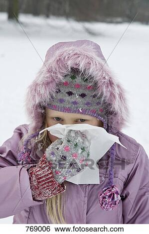 A young girl outdoors in snow blowing her nose View Large Photo Image Stock Photograph - A young girl outdoors in snow blowing her nose. Fotosearch