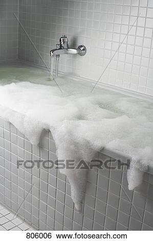 An overflowing bubble bath View Large Photo Image Stock Photograph - An overflowing bubble bath. Fotosearch