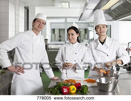 Chefs doing prep work in a commercial kitchen View Large Photo Image Stock Photography - Chefs doing prep work in a commercial kitchen. Fotosearch