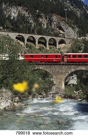 Glacier Express train crossing bridge over river, Graubuenden, Switzerland View Large Photo Image Stock Photo - Glacier Express train crossing bridge over river, Graubuenden, Switzerland. Fotosearch