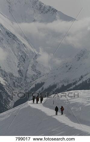 People hiking through snowy mountains, Graubuenden, Switzerland View Large Photo Image Stock Photo - People hiking through snowy mountains, Graubuenden, Switzerland. Fotosearch