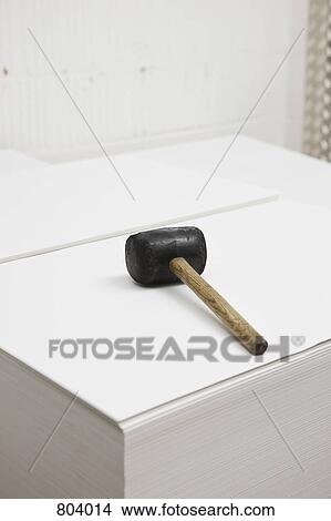 Rubber mallet on a stack of paper at a printers View Large Photo Image Picture - Rubber mallet on a stack of paper at a printers. Fotosearch