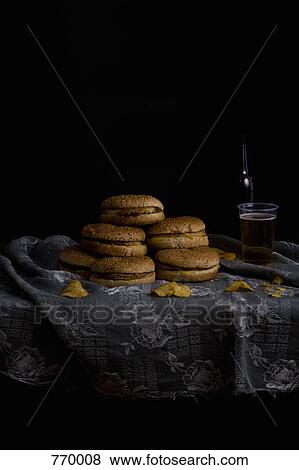 Stack of hamburgers and a beer, still life View Large Photo Image Stock Photo - Stack of hamburgers and a beer, still life. Fotosearch