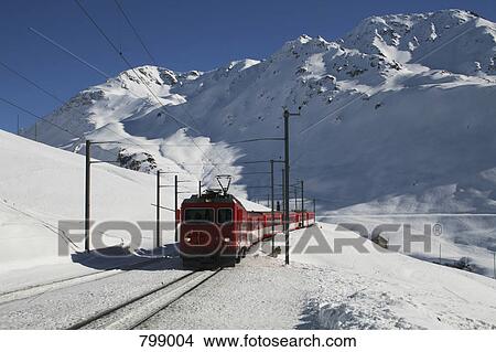 Train traveling through a mountain pass in winter, Andermatt, Uri, Switzerland View Large Photo Image Picture - Train traveling through a mountain pass in winter, Andermatt, Uri, Switzerland. Fotosearch