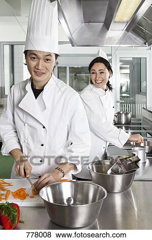 Stock Photo - Two chefs having fun while working. Fotosearch