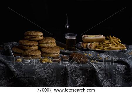 Stock Photo - Variety of fast food and beer bottle, still life. Fotosearch