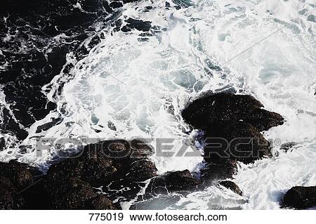 Waves crashing on a rock formation, Latrabjarg, Iceland View Large Photo Image Stock Photo - Waves crashing on a rock formation, Latrabjarg, Iceland. Fotosearch