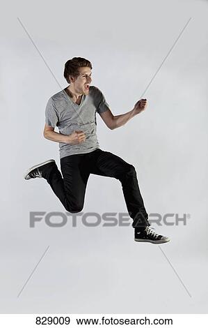 A man jumping in mid-air an excitement View Large Photo Image Stock Photo - A man jumping in mid-air an excitement. Fotosearch