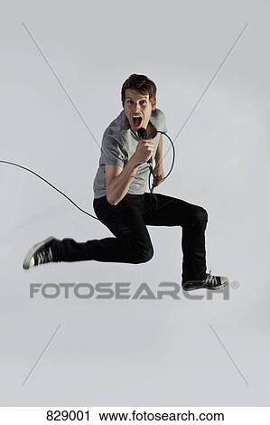 A singer jumping in mid-air View Large Photo Image Stock Image - A singer jumping in mid-air. Fotosearch