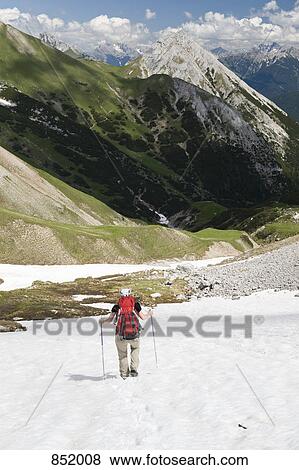 A woman hiking down one of The Wetterstein mountains View Large Photo Image Stock Photo - A woman hiking down one of The Wetterstein mountains. Fotosearch