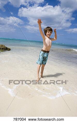 A young boy jumping on the beach, Cable Beach, Nassau, Bahamas, Caribbean View Large Photo Image Picture - A young boy jumping on the beach, Cable Beach, Nassau, Bahamas, Caribbean. Fotosearch