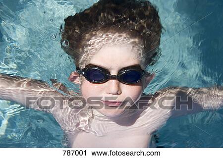 A young boy wearing goggles and floating in water View Large Photo Image Stock Image - A young boy wearing goggles and floating in water . Fotosearch