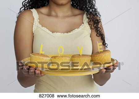 Detail of a woman holding cupcakes View Large Photo Image Stock Photo - Detail of a woman holding cupcakes. Fotosearch