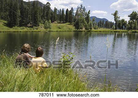 Two boys fishing at the edge of a lake, Durango, Colorado, USA View Large Photo Image Stock Image - Two boys fishing at the edge of a lake, Durango, Colorado, USA. Fotosearch