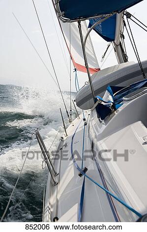 View from a sailboat sailing on the sea View Large Photo Image Stock Photograph - View from a sailboat sailing on the sea. Fotosearch