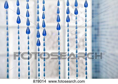 A beaded curtain hanging in a bathroom View Large Photo Image Picture - A beaded curtain hanging in a bathroom. Fotosearch