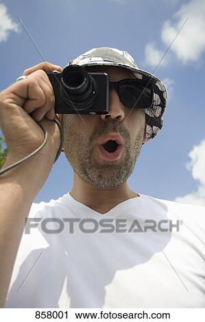 A man taking a photo with a digital camera View Large Photo Image Stock Image - A man taking a photo with a digital camera. Fotosearch