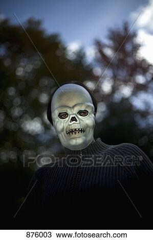 A man wearing a scary Halloween mask View Large Photo Image Stock Image - A man wearing a scary Halloween mask. Fotosearch