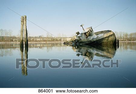 A shipwrecked boat in a lake View Large Photo Image Stock Image - A shipwrecked boat in a lake. Fotosearch