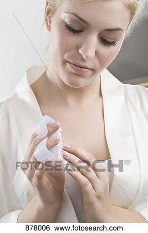 Stock Photograph - A woman using a nail brush. Fotosearch