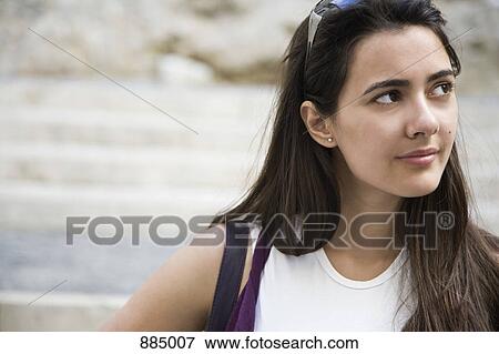 Stock Photo - A young woman looking away in contemplation. Fotosearch